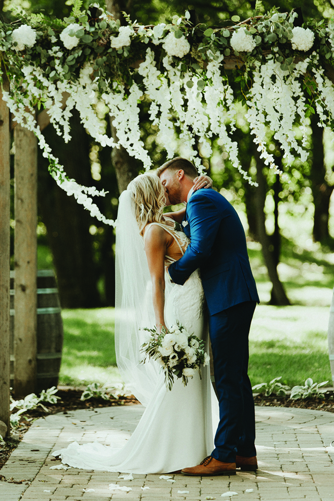 Lindsay and Hunter kiss at their Carlos Creek Winery wedding.