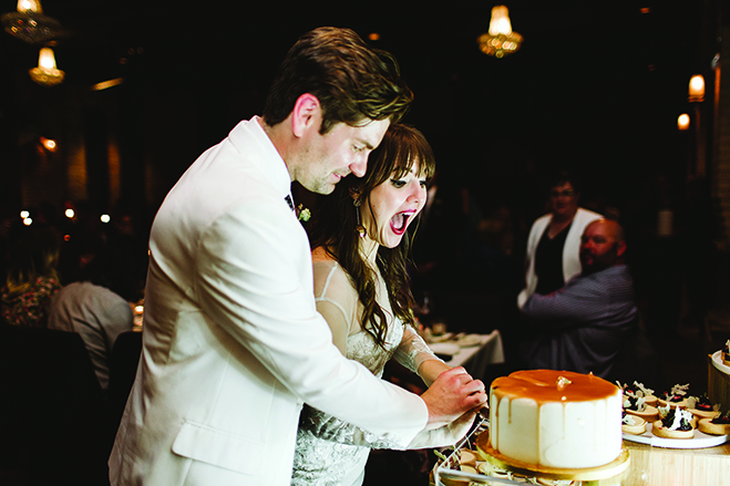 Sarah and Scott cut the cake at their wedding reception at the Hewing Hotel