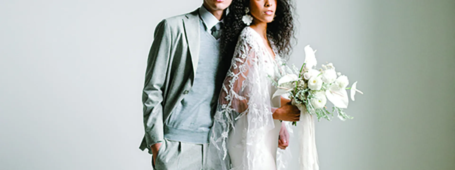 Grays and stark whites make up the bride and groom's attire