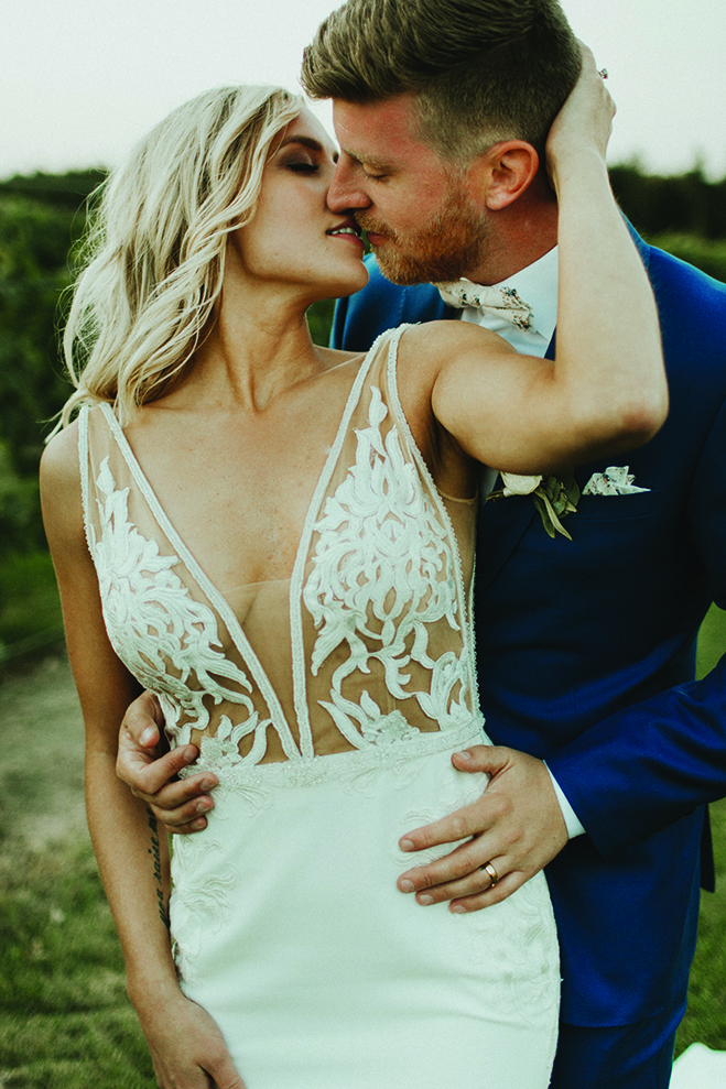Lindsay and Hunter kiss at their Carlos Creek Winery wedding.