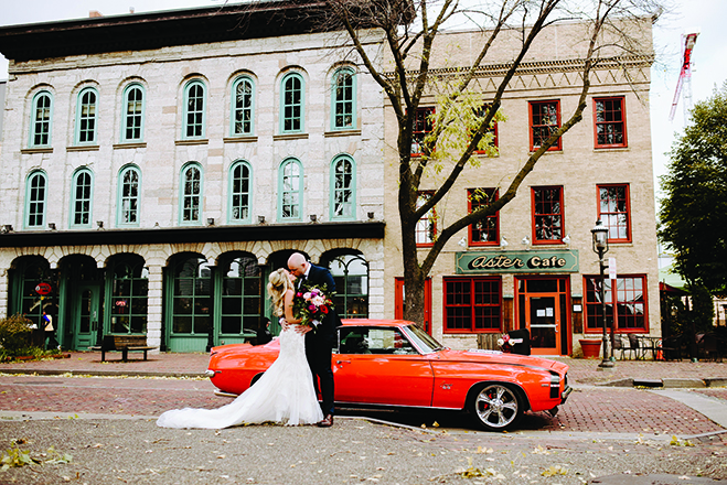 Molly and Seth kiss before an orange car in front of the Aster Cafe.
