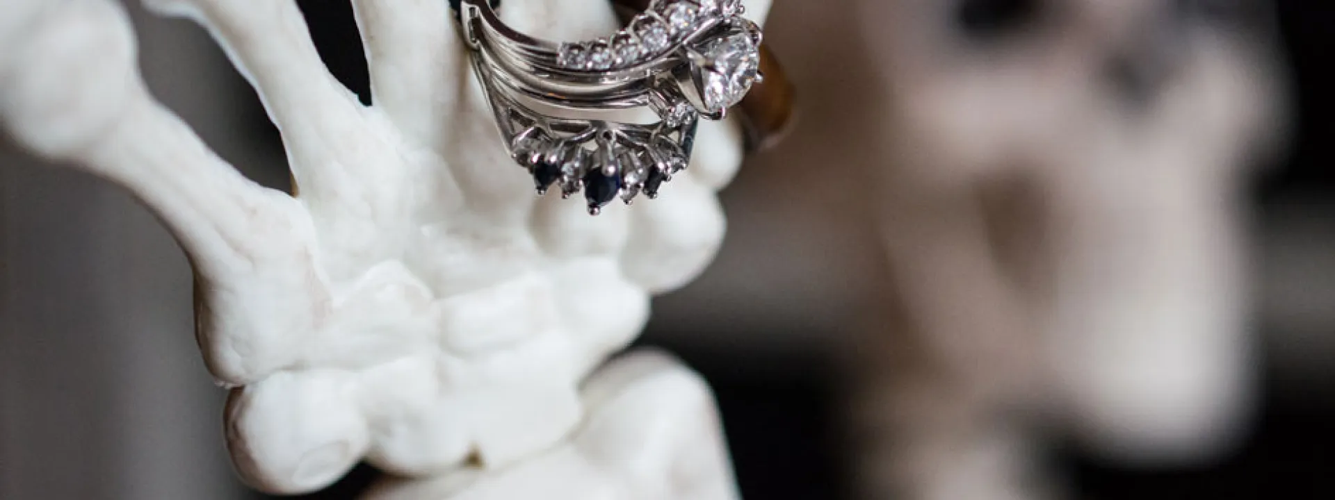 A skeleton displays the bride's rings at the entrance to Mayowood Stone Barn